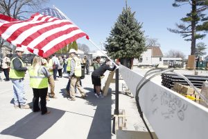 Students sign a beam at the Ryan Center Topping Off Ceremony.