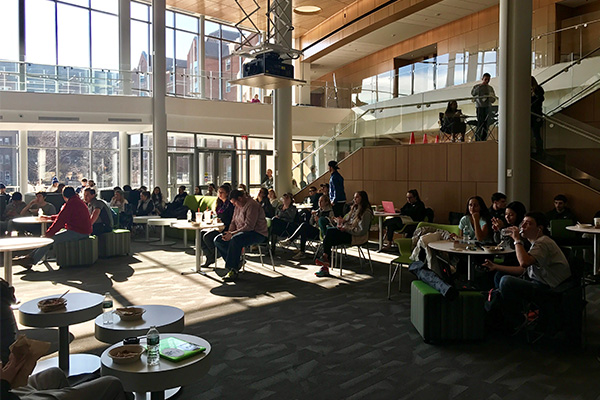 PCSB students, faculty, and administrators gather in the Palmisano Atrium for the PC Men's Basketball game watch.