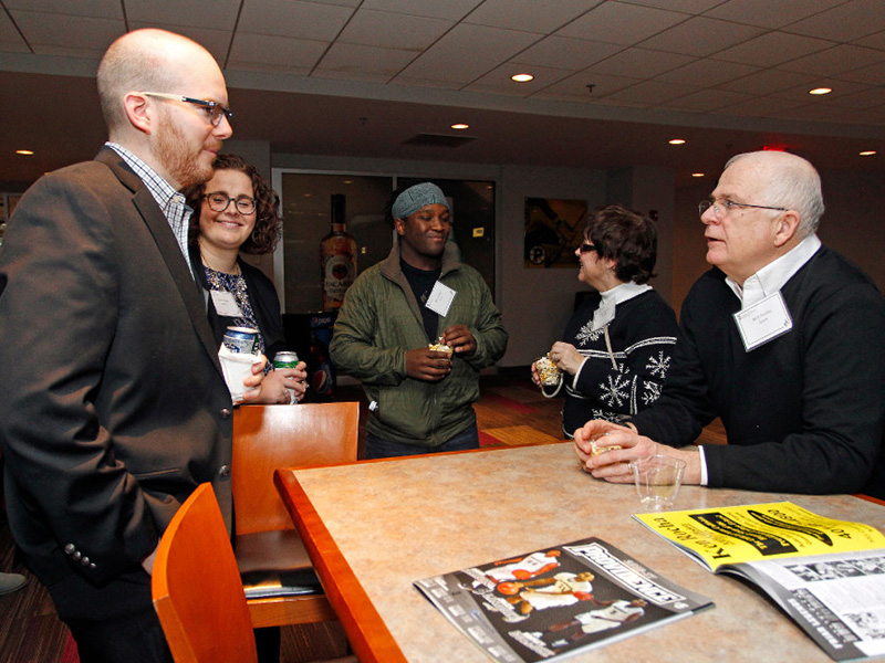 MBA students and alumni network with faculty and staff