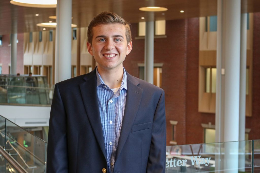 Kevin O'Neill '18 poses along Never Better Way in the new Ryan Center