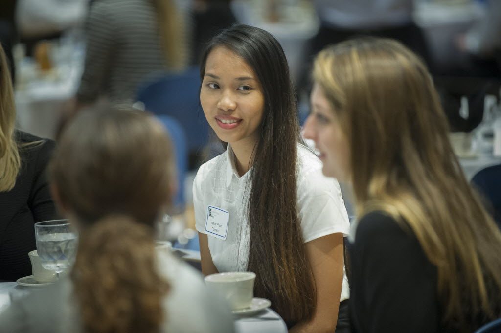 Ruby Pham, MBA '15, speaks with peers at the MBA Program orientation.