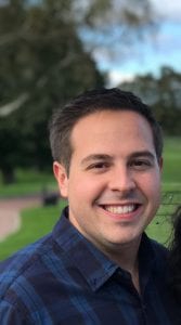 man smiling at the camera, cropped to just the head