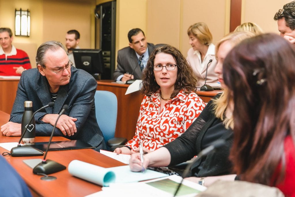 Photo of adult students discussing a class topic