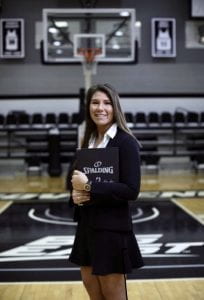 Professional Woman with folder on basketball court