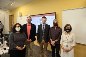 Photo of dean, professor and Samsonite executives in a classroom