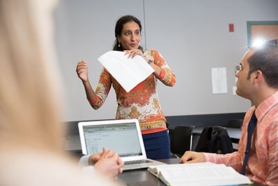 Professor teaching with a student in the foreground