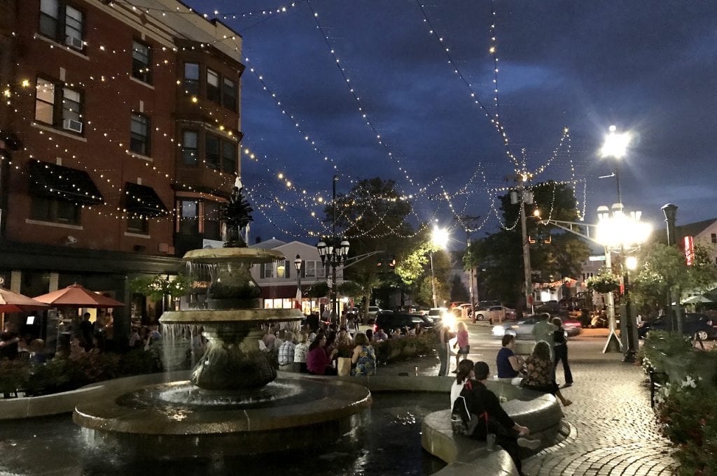 A fountain on Federal Hill illuminated at night.