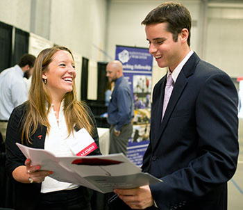 A student networks with a prospective employer at the Career Expo.