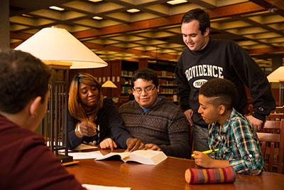 Business students hold a group meeting in the library.