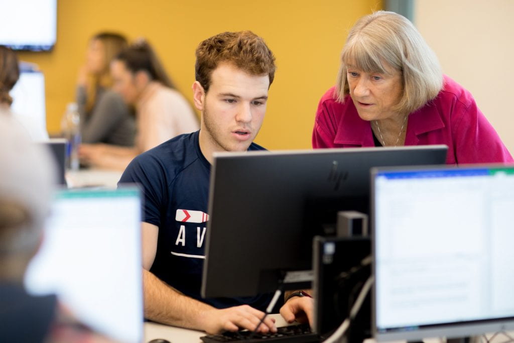 Professor and Student looking at computer screen