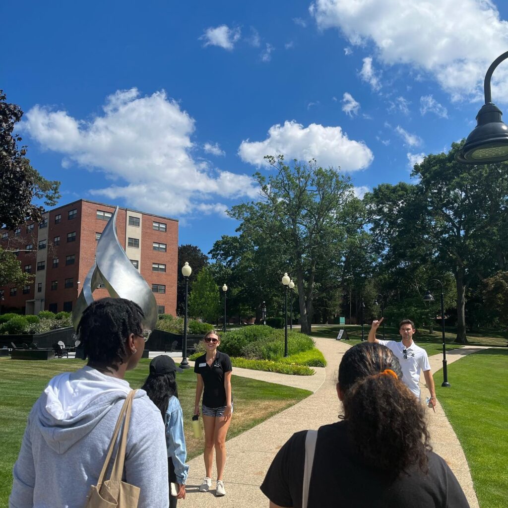 Four Students walking through campus on a sunny day