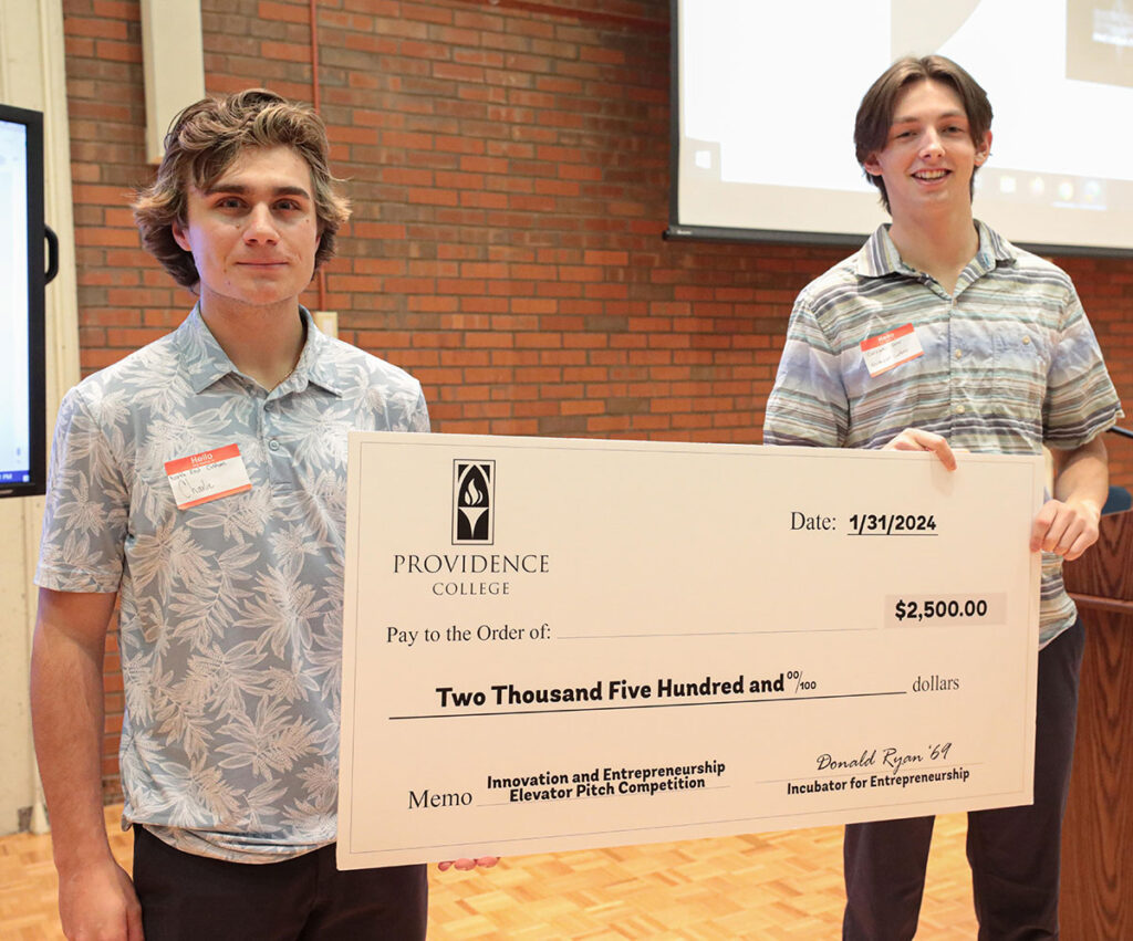 Charles Baroni ’26 and Chris Daley ’26 of Northeast Customs hold their check for second prize at the Elevator Pitch Competition.