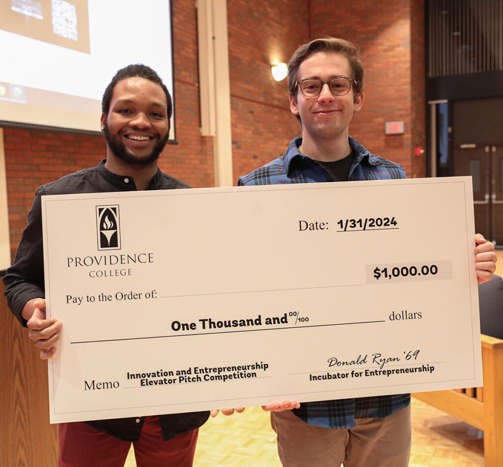 Dory Aine ’24 and Josh Cohn ’24 of D&J Marketing post with their third-prize check at the Elevator Pitch competition.