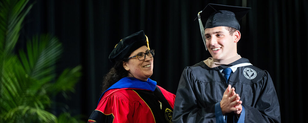 Women and Man in academic regalia
