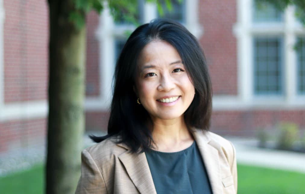 Laura Lam outside academic building.